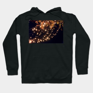 Lights draping off the Tree with a Black Sky in the background Hoodie